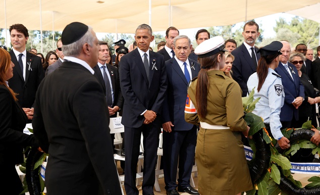 US President Barack Obama stands alongside Israeli Prime Minister Benjamin Netanyahu, center right, as Israeli military pass by with wreaths of flowers during the funeral of former Israeli President, Shimon Peres, 93, on Mt. Herzl Cemetery in Jerusalem, Friday, Sept. 30, 2016. At right is Spain's King Felipe VI next to Israeli President Rueven Rivlin, and at left is Canadian Prime MinistercJustin Trudeau. (Abir Sultan, Pool via AP)