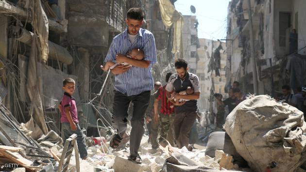 TOPSHOT - Syrian men carrying babies make their way through the rubble of destroyed buildings following a reported air strike on the rebel-held Salihin neighbourhood of the northern city of Aleppo, on September 11, 2016. Air strikes have killed dozens in rebel-held parts of Syria as the opposition considers whether to join a US-Russia truce deal due to take effect on September 12. / AFP / AMEER ALHALBI (Photo credit should read AMEER ALHALBI/AFP/Getty Images)